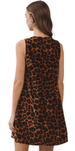 Load image into Gallery viewer, A woman shown from the back wearing a sleeveless A-line dress with a brown and black leopard print pattern, set against a plain light gray studio background.