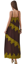 Load image into Gallery viewer, A woman modeling a brown maxi dress from the back, featuring olive green lace trim in diagonal stripes and along the neckline, straps, and hem.