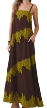 Load image into Gallery viewer, A woman wearing a sleeveless maxi dress in dark brown with olive green lace trim, photographed against a plain light background.